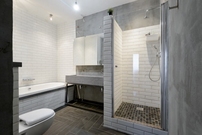 una combinación de azulejos y hormigón en el baño
