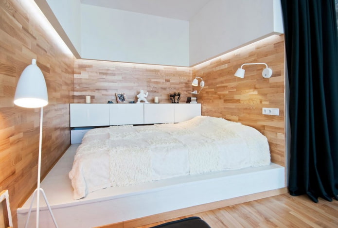 cama sobre un podio monolítico en el interior