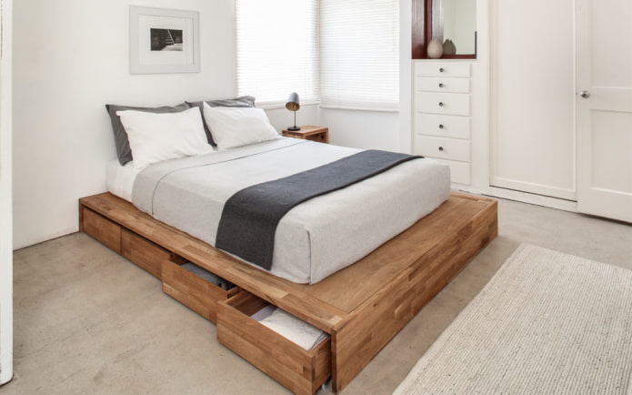 Cama de madera con cajones en el interior