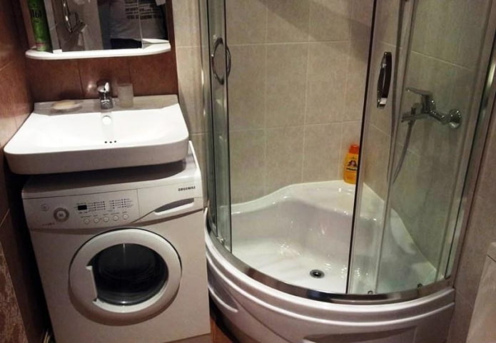 Cabina de ducha y lavadora bajo el lavabo