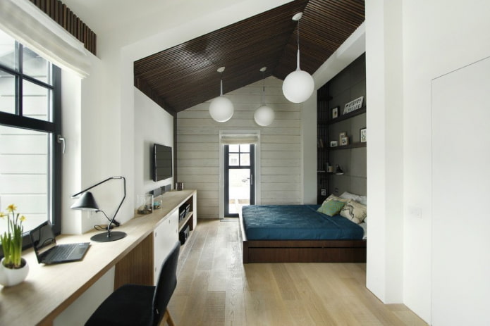 diseño de un dormitorio abuhardillado con puesto de trabajo